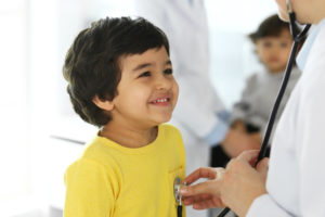 Doctor examining a child patient by stethoscope. 